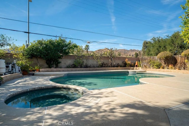 view of pool with an in ground hot tub