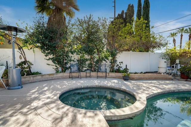 view of swimming pool with an in ground hot tub and a patio area