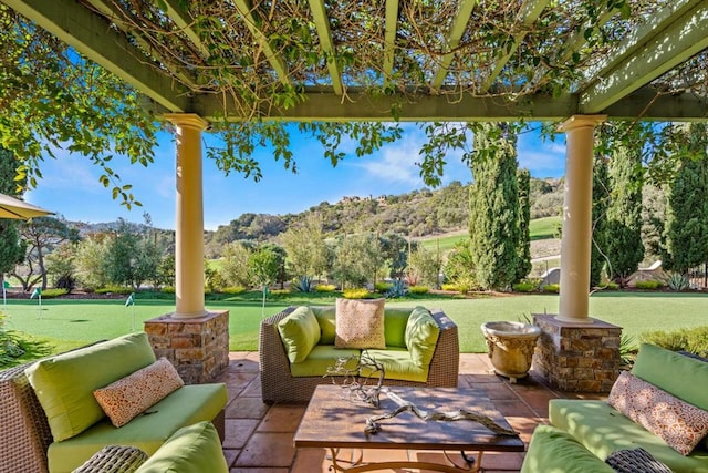 view of patio / terrace with an outdoor living space and a mountain view