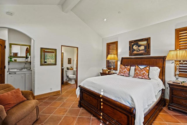 bedroom with sink, ensuite bathroom, beam ceiling, and tile patterned flooring