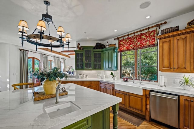 kitchen with sink, stainless steel dishwasher, and a wealth of natural light