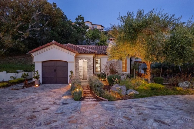 mediterranean / spanish-style home featuring a garage