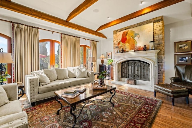 living room featuring hardwood / wood-style floors, beam ceiling, and a fireplace