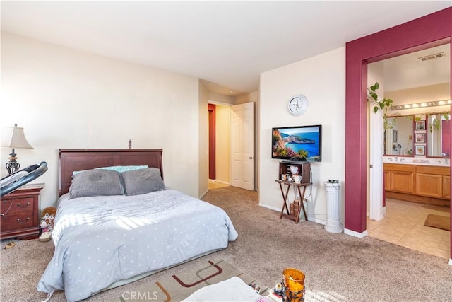 carpeted bedroom with ensuite bathroom