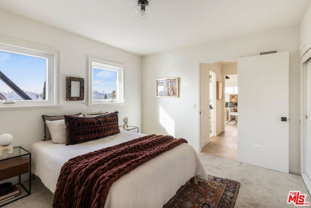 bedroom featuring light carpet