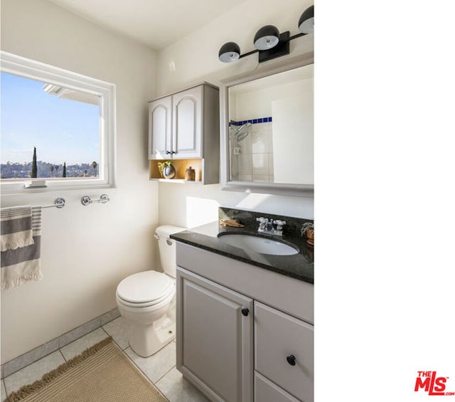 bathroom featuring tile patterned flooring, vanity, toilet, and a shower with shower curtain