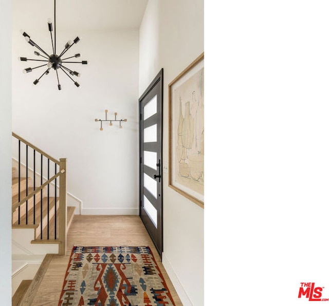 entryway featuring a chandelier and light wood-type flooring