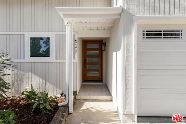 view of exterior entry featuring a garage