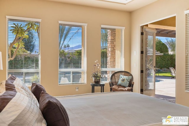 bedroom with access to outside and multiple windows