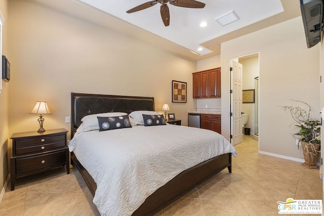 bedroom featuring ceiling fan, ensuite bath, and light tile patterned flooring