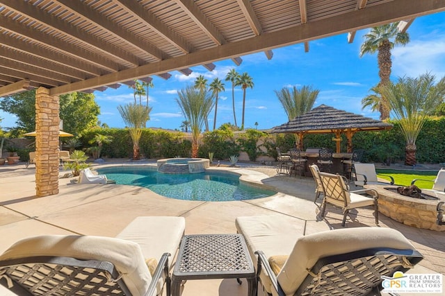 view of pool with a fire pit, an in ground hot tub, a patio, and exterior bar