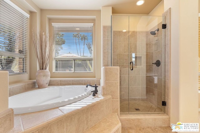 bathroom featuring separate shower and tub