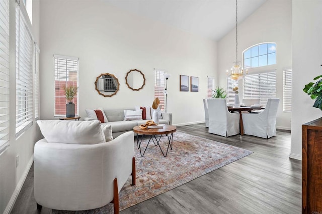 living room featuring a high ceiling, hardwood / wood-style floors, and a chandelier