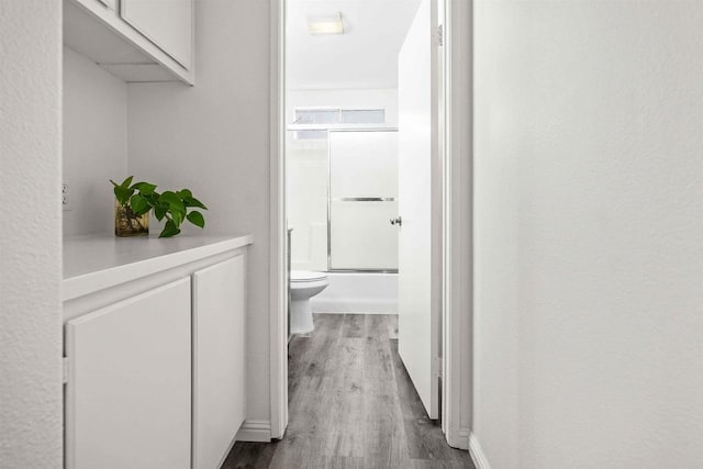 hall with dark hardwood / wood-style floors