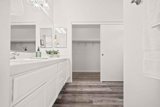 bathroom with hardwood / wood-style floors and vanity