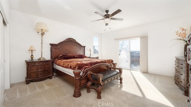 carpeted bedroom featuring access to exterior and ceiling fan