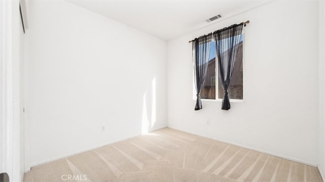 unfurnished room with light carpet