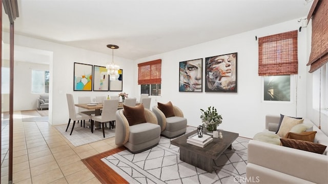 living room with light tile patterned floors and a notable chandelier