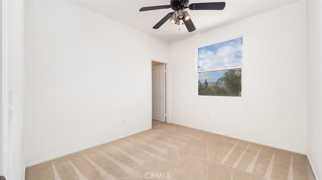 unfurnished room with ceiling fan and light carpet