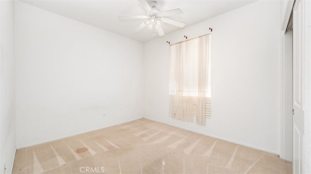 unfurnished room with ceiling fan and light carpet