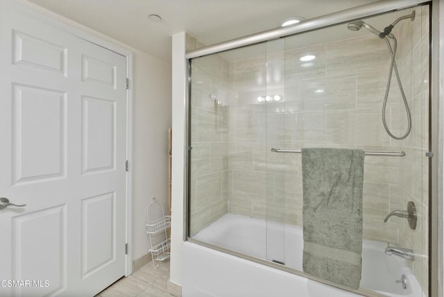 bathroom featuring combined bath / shower with glass door and tile patterned flooring