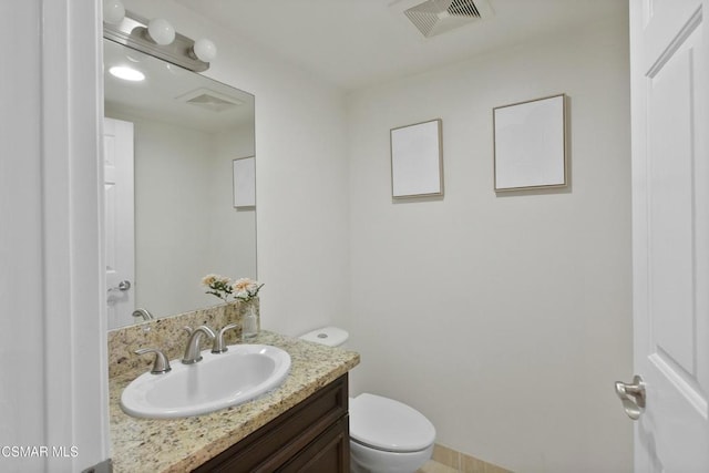 bathroom featuring toilet and vanity