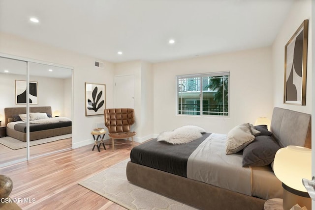 bedroom with a closet and light hardwood / wood-style floors