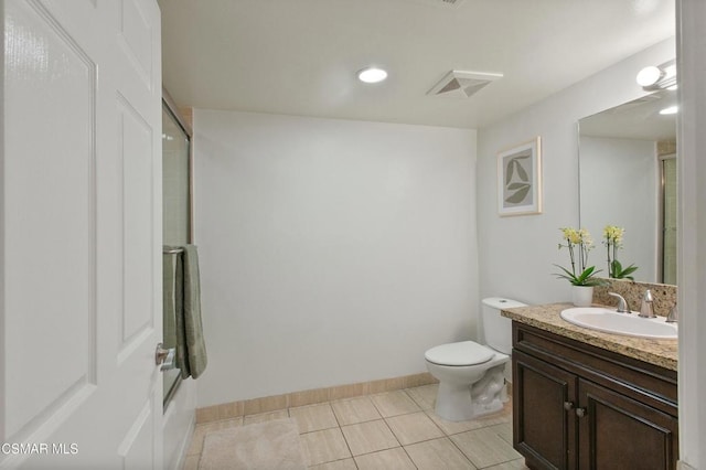 bathroom featuring vanity, toilet, tile patterned floors, and a shower with door