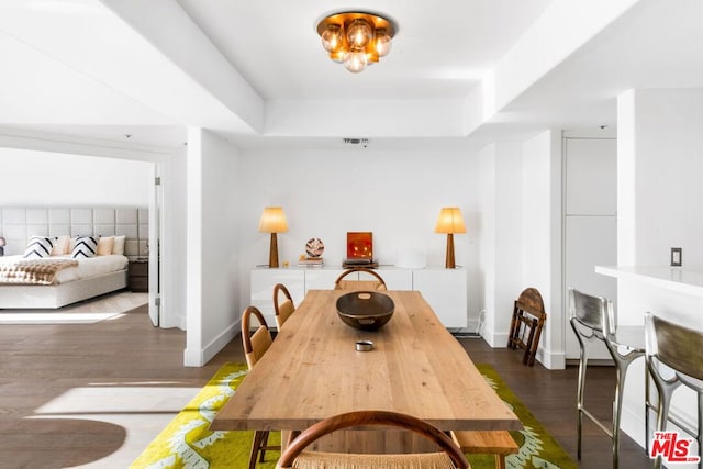 dining space with dark wood-type flooring