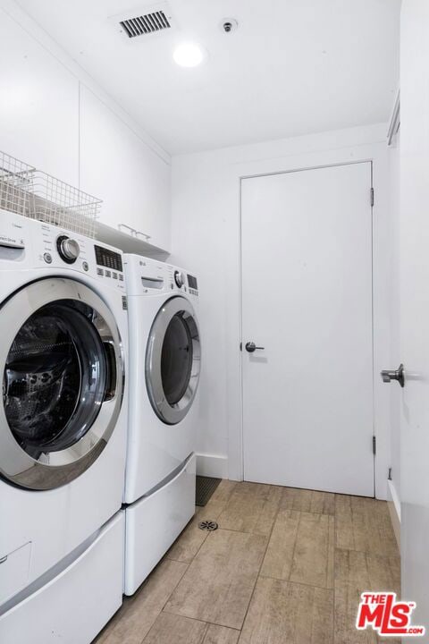 laundry area with independent washer and dryer