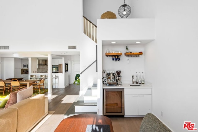 bar featuring sink, dark hardwood / wood-style floors, appliances with stainless steel finishes, and decorative backsplash