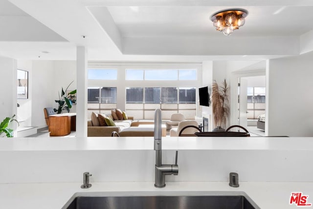 kitchen featuring sink and a raised ceiling