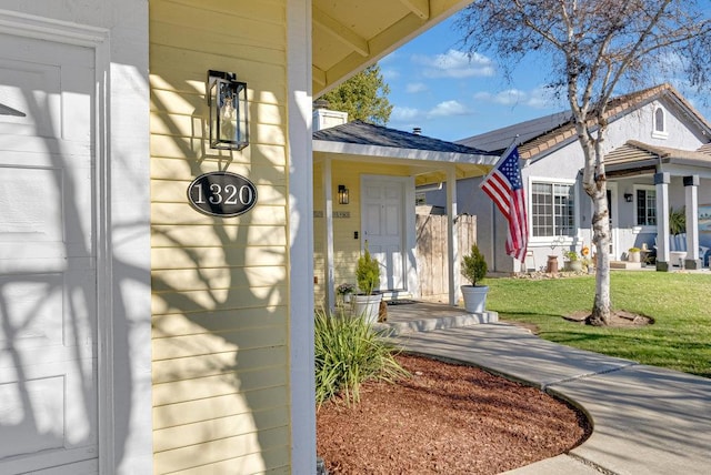 property entrance featuring a lawn