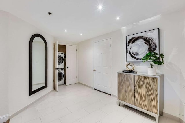 hall featuring stacked washer and clothes dryer