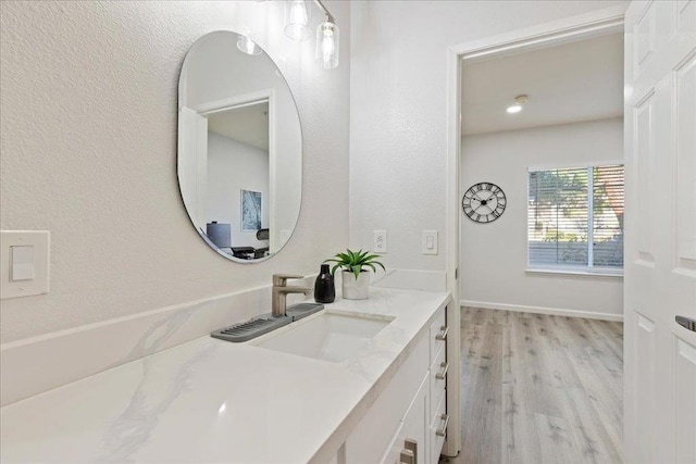 bathroom featuring hardwood / wood-style flooring and vanity