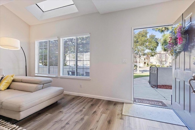 interior space with light hardwood / wood-style flooring and a skylight