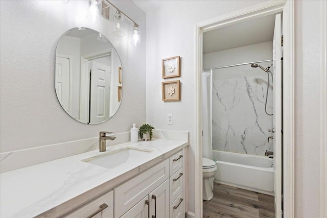 full bathroom featuring shower / bath combo with shower curtain, hardwood / wood-style floors, toilet, and vanity