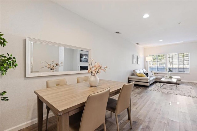 dining space with hardwood / wood-style flooring