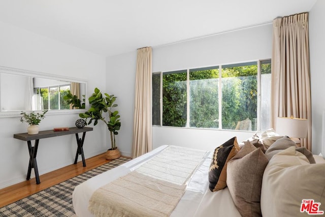 bedroom featuring wood-type flooring and multiple windows