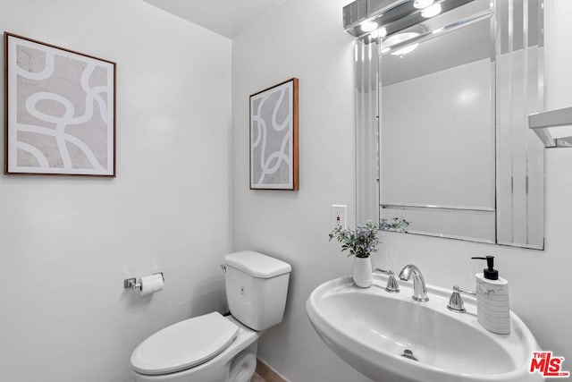 bathroom featuring sink and toilet