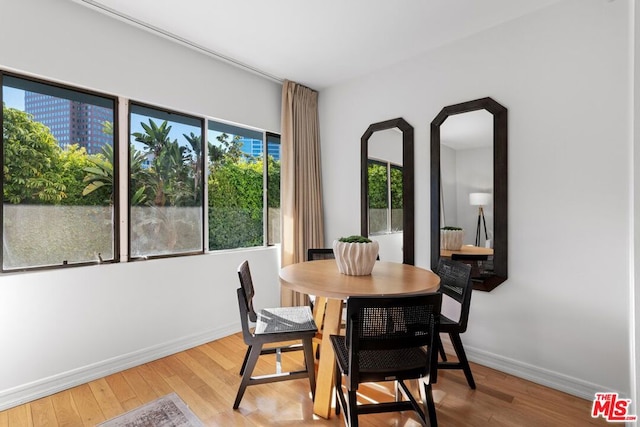 dining space featuring hardwood / wood-style floors and plenty of natural light