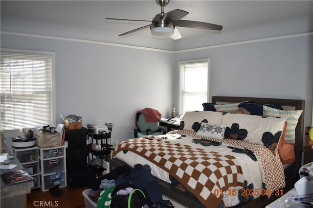 bedroom featuring ceiling fan, hardwood / wood-style flooring, and crown molding