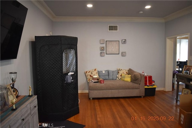 living room featuring hardwood / wood-style floors and crown molding