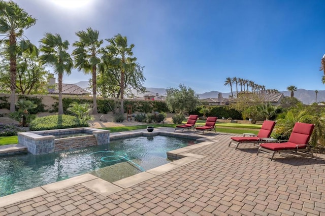 view of swimming pool with an in ground hot tub, pool water feature, and a patio