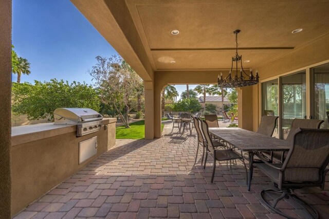 view of patio / terrace with an outdoor kitchen and a grill