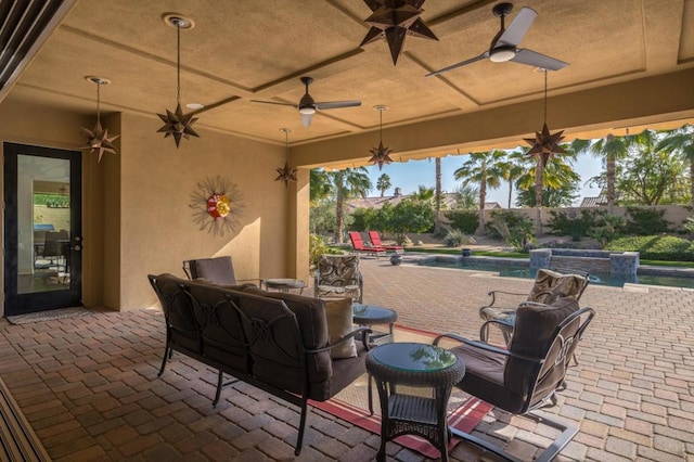 view of patio / terrace with an outdoor living space and a fenced in pool