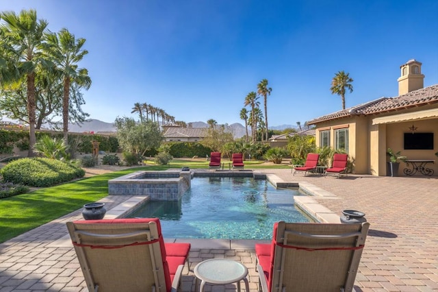 view of swimming pool featuring an in ground hot tub and a patio