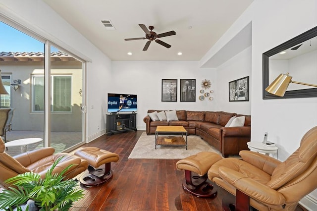 living room with dark wood-type flooring and ceiling fan