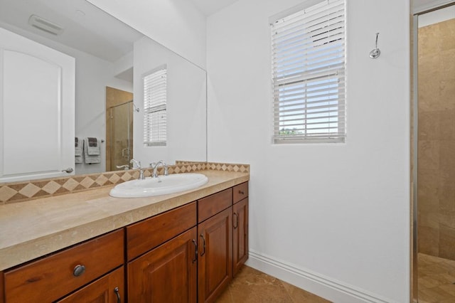 bathroom featuring vanity, an enclosed shower, and tile patterned flooring