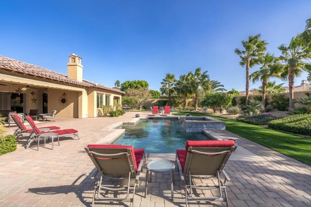 view of pool with an in ground hot tub and a patio area